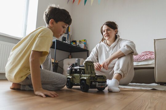 Mother and child bonding at home with toys
