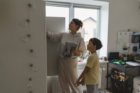 Mom and son bonding at home during daily chores