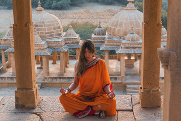 Woman meditating in temple with traditional attire