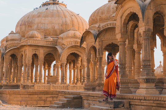 Woman in traditional attire at historic Indian temple