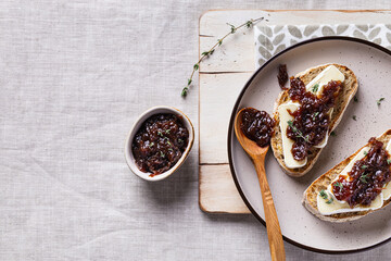 Red onion marmalade spread on rustic bread slices