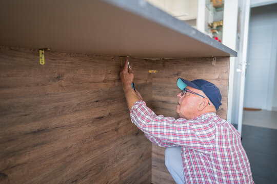 Senior engaging in home renovation kitchen task