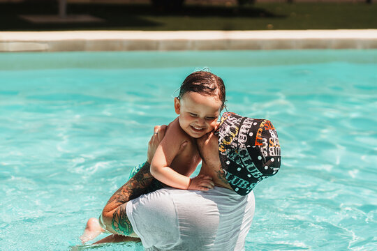 Father and child enjoying summer pool time