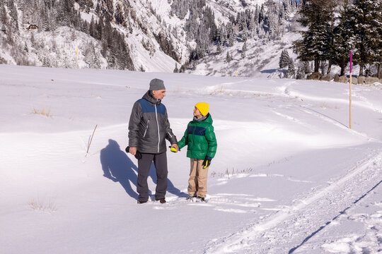 Walk through a snowy valley with family and child