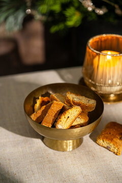 Italian cantuccini in a brass bowl with candlelight