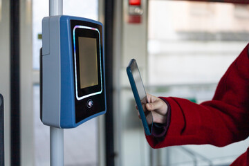 Woman using smartphone for contactless transit payment