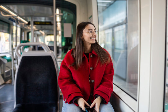 Woman in red coat enjoying a cozy winter ride