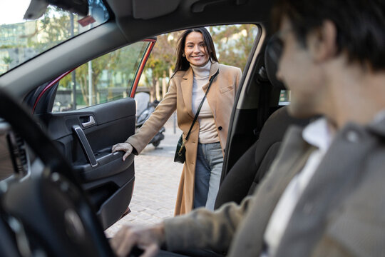 Young couple beginning a road trip in their car