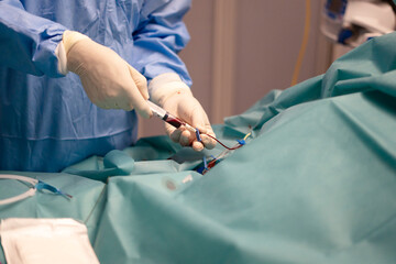 Nurse inserting peripheral venous line in hospital ICU