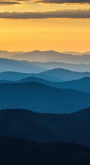 Fototapeta premium Golden hour light illuminating high peaks, casting shadows across the vast atmospheric landscape of rolling blue hills ,vista ,wilderness ,vibrant