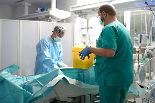 Nurse inserting peripheral IV in ICU for patient care
