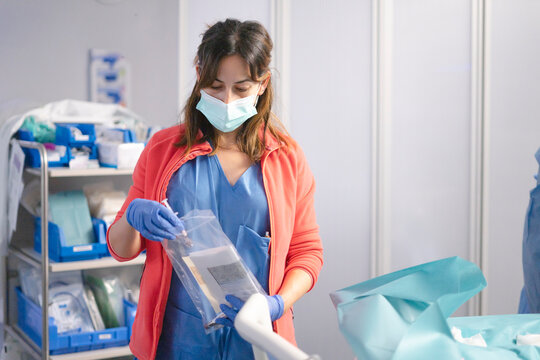 Nurse organizing surgical tools in a clinical setting