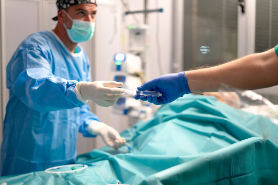 Nurse prepares peripheral venous line in icu setting