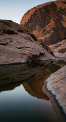 Rugged, ancient desert rock formation contrasting with the smooth, cool surface of a vital water source in a remote, harsh environment ,harsh ,geology ,desert