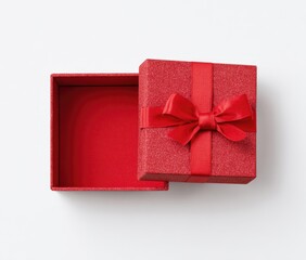 A partially opened, textured red gift box with a ribbon bow, sits on a white surface