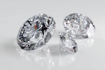 Three clear cut diamonds sparkle on glossy white surface, close-up, eye-catching