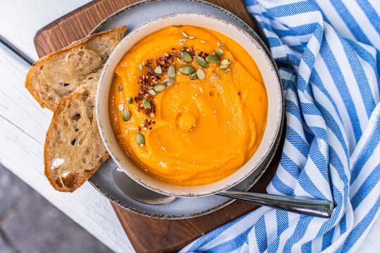 Creamy pumpkin soup with rustic bread slices