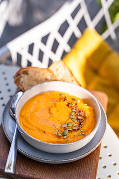Creamy pumpkin soup served with crusty bread