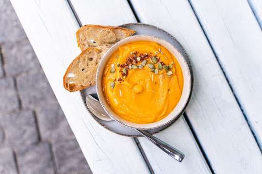 Autumnal pumpkin soup with rustic bread slices