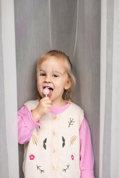 Little girl enjoying a sweet lollipop treat