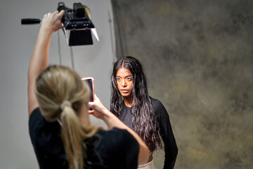 Confident woman with wet hair at photoshoot studio