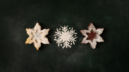  Christmas background with gingerbread cookies in the shape of stars on a dark green background...