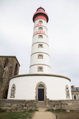 The lighthouse and abbey ruins at St Matthew point, a headland located in the commune of Plougonvelin in Finistere, Brittany, France. Vertical shot.