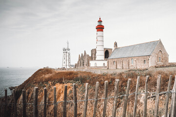 The lighthouse, chapel and abbey ruins at St Matthew point, a headland located in the commune of Plougonvelin in Finistere, Brittany, France. Toned image.