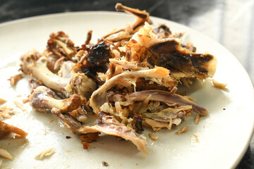 Chicken bones on a plate.