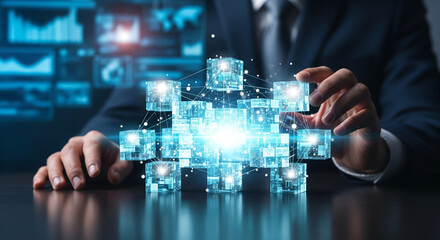 Businessman building digital network with glowing cubes in futuristic office