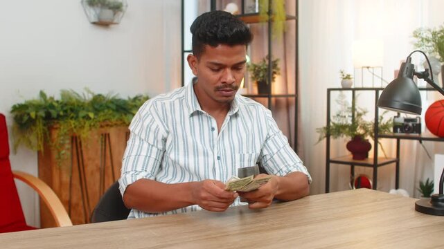 Indian man at home opens wallet counts small bills feels low cash and sighs plans strict budget. Arabian guy at desk checks list of debts sets savings goal cancels extras and writes plan to recover.