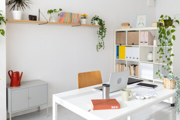 Minimal home office desk with laptop and coffee. Bright cozy workspace with natural light and clean design for remote work. Freelance and productivity concept.