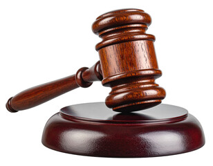 Close-up studio shot of a brown wooden gavel atop a matching sound block, isolated on black