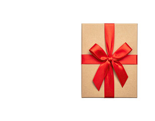 Overhead shot of a square gift box with a vibrant red ribbon bow, on black background