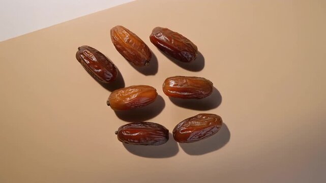 Seven premium dates placed on a neutral surface with a smooth beige-to-white gradient background.