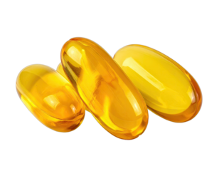 Close-up of three yellow, oval-shaped soft gel capsules arranged against a black backdrop