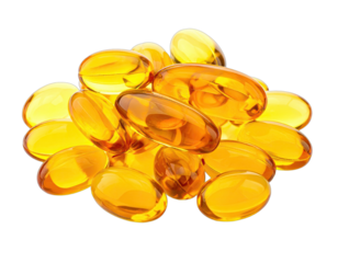 Close-up of translucent, amber-colored softgel capsules, piled on a black backdrop