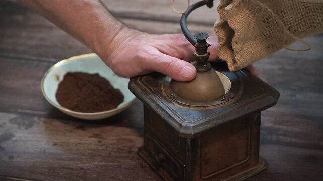 Grinding coffee with an old-fashioned grinder