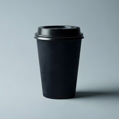 Black disposable coffee cup with lid on gray background