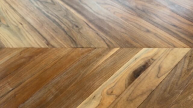 Close up of a hand removing a spray bottle and microfiber cloth from a wooden table. Cleaning finished, home organization, and household tidying concept.