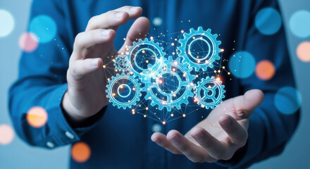 A digital rendering showcases hands holding glowing blue gears against a blurred background. Depicts technology and engineering in a futuristic style. 