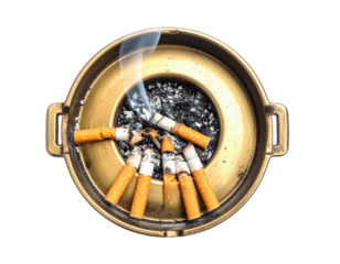 Close-up of a brass ashtray overflowing with extinguished cigarettes and wisps of smoke