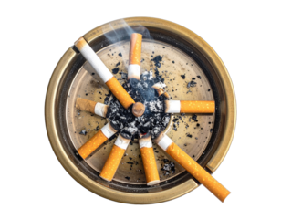 Overhead shot of brass ashtray with spent cigarettes and ash arranged in radial pattern