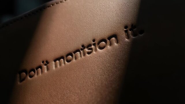 Close up of the words Dont mention it engraved on skin.