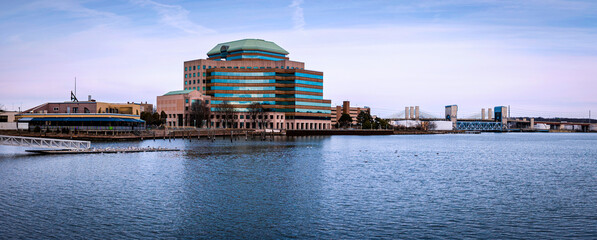 New Haven seascape over Long Wharf Pier with historic landmark architecture, Tomlinson Bridge, and water reflections in New Haven Harbor, Connecticut, United States