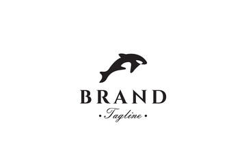 Fototapeta premium Orca whale logo with a flat black vector design style and distinctive white eyes