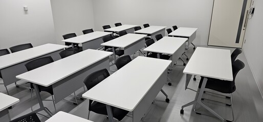 Empty modern classroom interior with desks and copy space for education and training