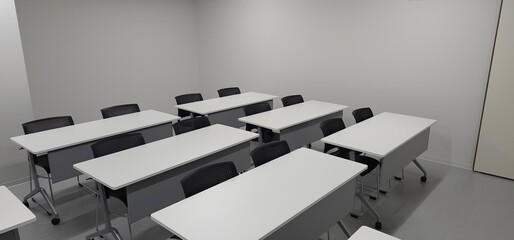Empty modern classroom interior with desks and copy space for education and training