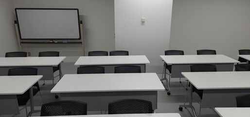 Empty modern classroom interior with desks and copy space for education and training