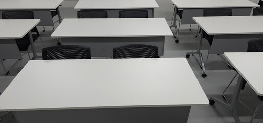 Empty modern classroom interior with desks and copy space for education and training
